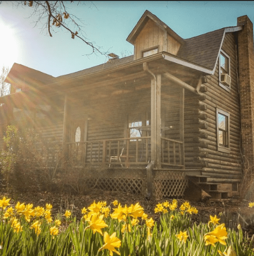 A house with flowers in front of it.