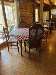 A table with four chairs and a checkered tablecloth.